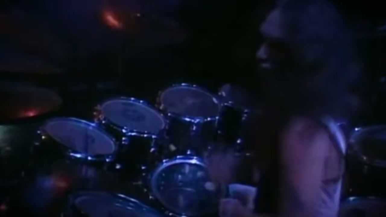 Live shot of drums on a stage with blue lighting